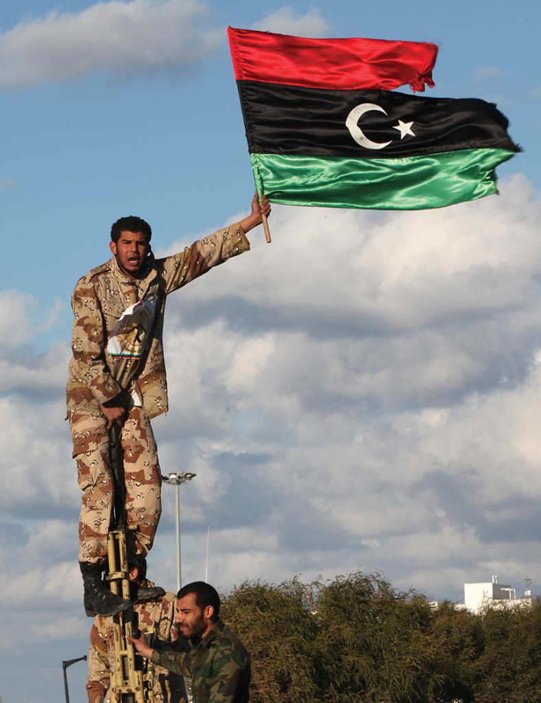 A Libyan man waves his nation’s flag in advance of the first anniversary of the overthrow of Moammar Gadhafi. After the fall of Gadhafi, weapons began to flow out of Libya into the Sahel.