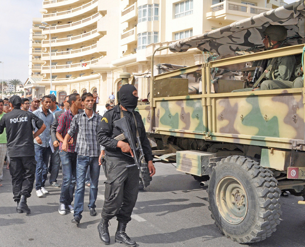 Tunisian security forces inspect the area of a failed suicide bomb attack near the Riadh Palms Hotel in Sousse in October 2013. Nongovernmental organization funding has allowed extremists in Tunisia to ply the population with aid to build support.  [AFP/GETTY IMAGES]