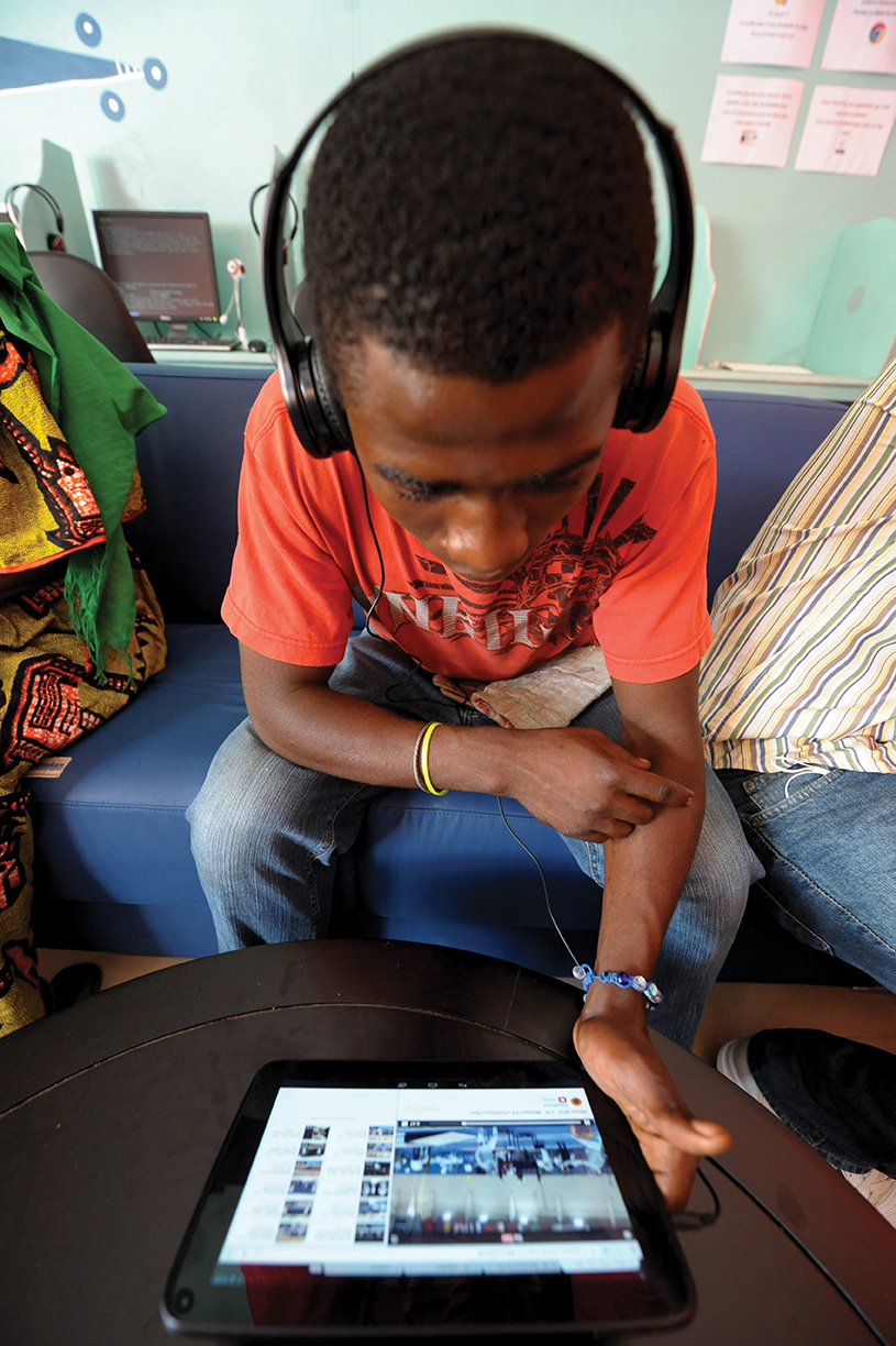 Un client utilise une tablette dans un cybercafé, dans le district Medina de Dakar, au Sénégal.