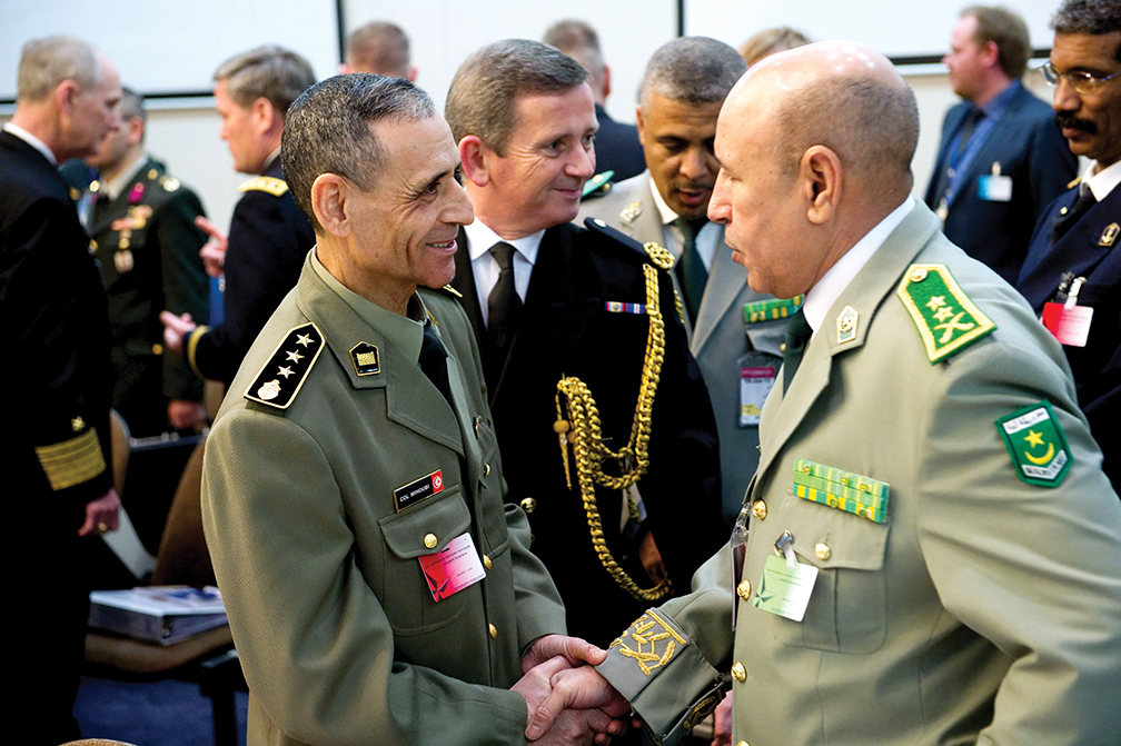 Lt. Gen. Mohamed Ghazouani, right, meets with Col. Mohamed Mihoubi, a military attaché for Tunisia, during the 166th NATO Chiefs of Defence meeting in Brussels, Belgium.  [NATO]