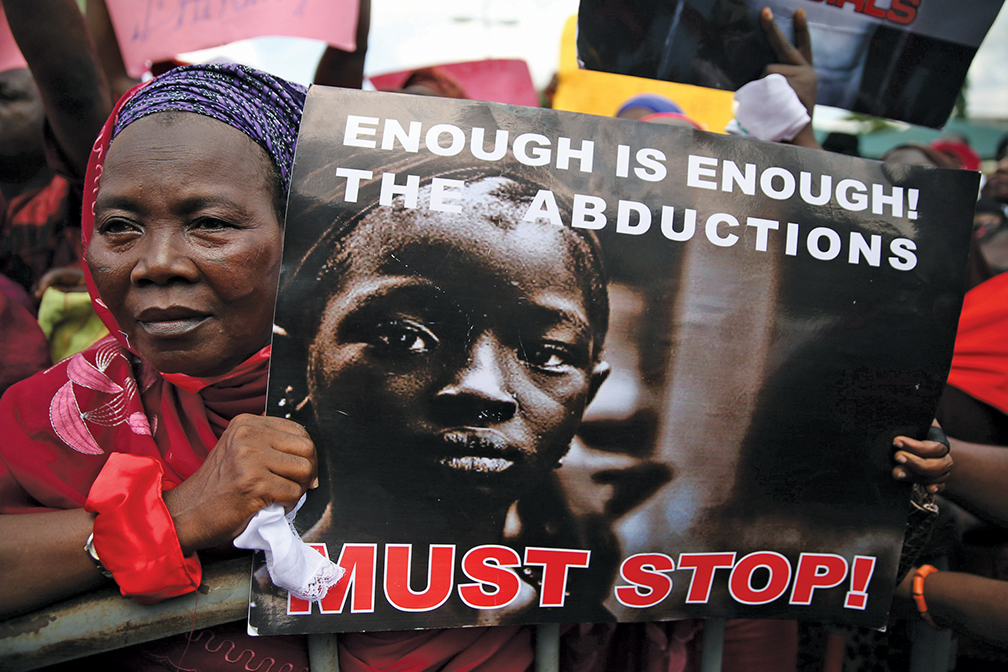 A woman holds a sign during a protest in Lagos in May 2014 demanding the release of 276 abducted secondary school girls from the remote village of Chibok. [reuters]