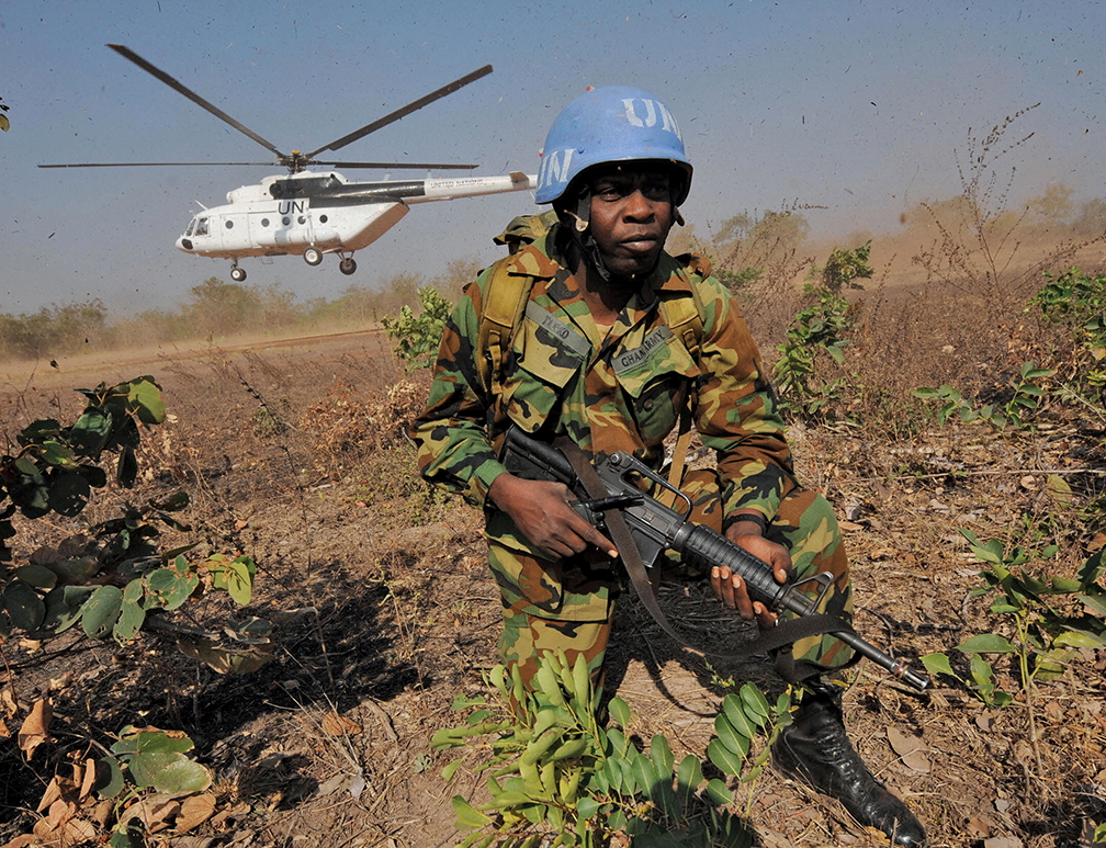 A Ghanaian peacekeeper in Côte d’Ivoire exits an army helicopter. Ghana has contributed about 80,000 peacekeepers to 31 U.N. missions in the past four decades. [afp/getty images]