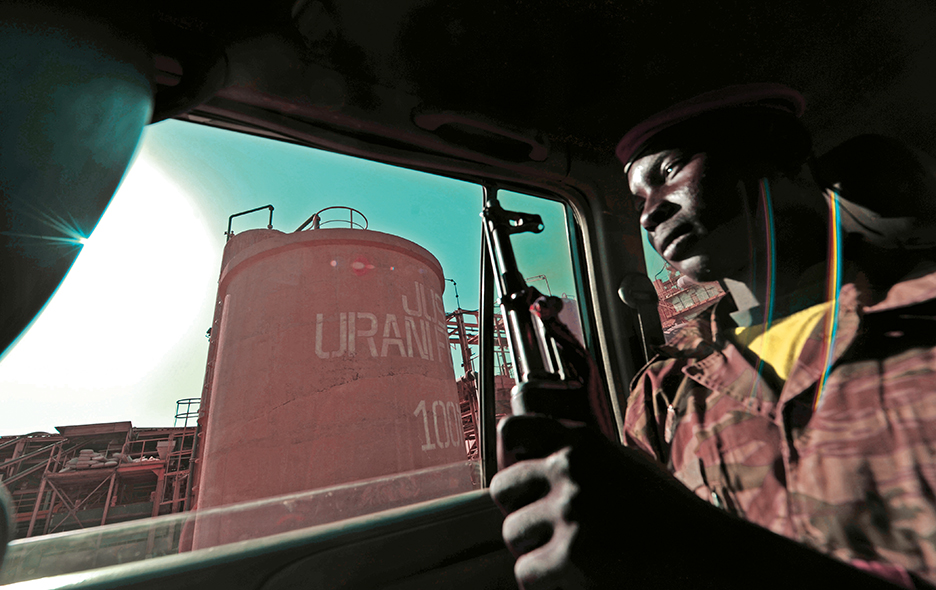 Nigerien soldier sits inside a car escorting press members outside  France's state-owned nuclear giant Areva's uranium mine on September 26, 2010 in Arlit.    Gunmen seized the five French nationals, most working for France's state-owned nuclear giant Areva or its engineering sub-contractor Satom, amd a Togolese and a Madagascan in a raid on September 16 on a uranium mining town in the deserts of northern Niger. Army chiefs and counter-terrorism experts from the Sahel region were meeting Sunday in southern Algeria in a bid to come to grips with the growing threat of Al-Qaeda-linked militants. AFP PHOTO / ISSOUF SANOGO (Photo credit should read ISSOUF SANOGO/AFP/Getty Images)