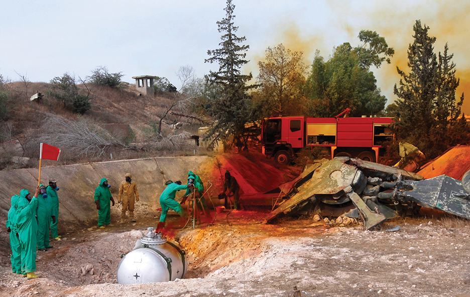 A team of Libyan experts and military engineers dump away fuel from expired SA-2 missiles, under the supervision of the United Nations, in Tripoli November 11, 2012. Experts were assigned to dump the toxic chemicals found in the air defense missiles left over from the former Gaddafi's regime. REUTERS/Ismail Zitouny (LIBYA - Tags: POLITICS MILITARY ENVIRONMENT) - RTR3A9TD