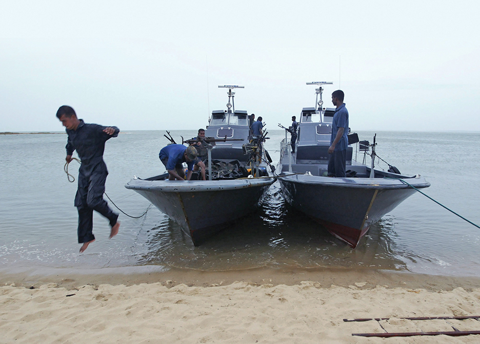 A Sri Lankan navy sailors arrive in  Kalpitiya , about 40 kilometers north of the capital Colombo, Sri Lanka on Sunday, July 2, 2006. Security has been tightened along the island's western coast amid recent increase of attacks by the sea tigers, the naval wing of the separatist Tamil tiger rebels. (AP Photo/Eranga Jayawardena)