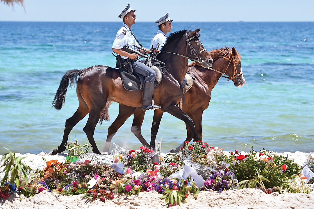 Armed police patrol Marhaba beach in Sousse, Tunisia, in June 2015 after a terrorist attack there killed 38 people. AFP/GETTY IMAGES 